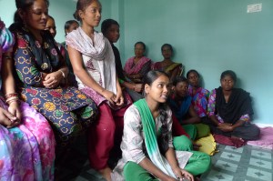 Students of the tailoring program speak to MCC staff at the BICWS Field Office. Seated on the floor is Poonam Thakur; behind her is her teacher, Hena Gurung, herself a graduate from the program, and Hannah ??, of BICWS.